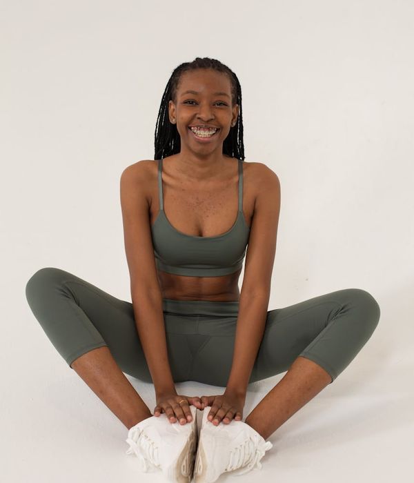 Woman in activewear performing a light cardio exercise in a bright studio.